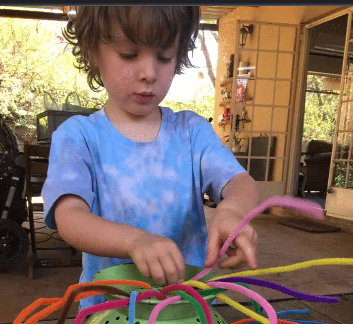 Allowing Your Kid to Insert Colorful Straws Into a Can
