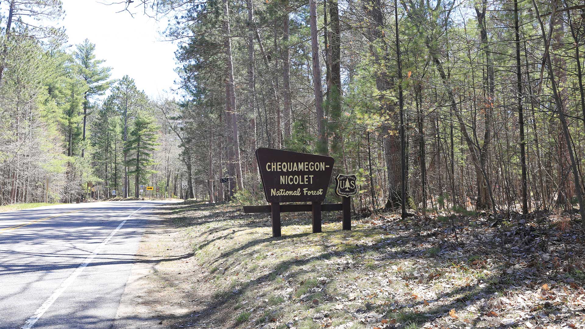 A roadside sign in Chequamegon-Nicolet National Forest, offering guidance and highlighting the natural beauty of the area