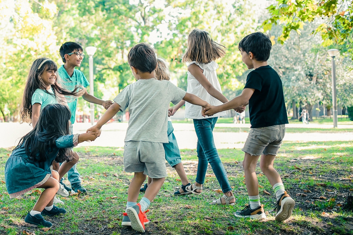Children playing in a park, enjoying environmental-themed games