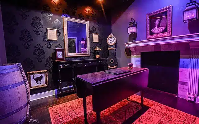 A well-furnished room with a desk, clock, and mirror, perfect for an escape room adventure