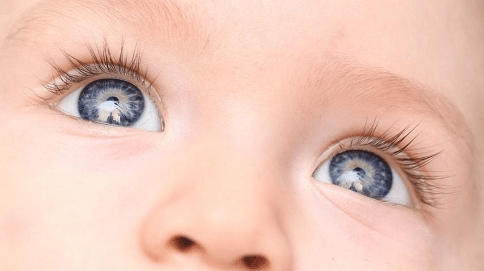 A close-up of a baby's blue eyes, showcasing the enchanting innocence and purity of their gaze