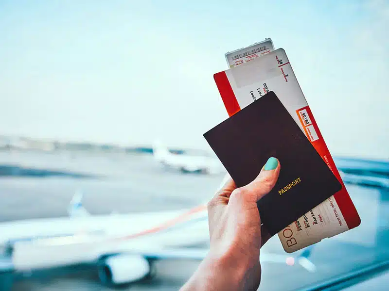  a passport and an airplane, representing the key elements of budget-friendly holiday planning