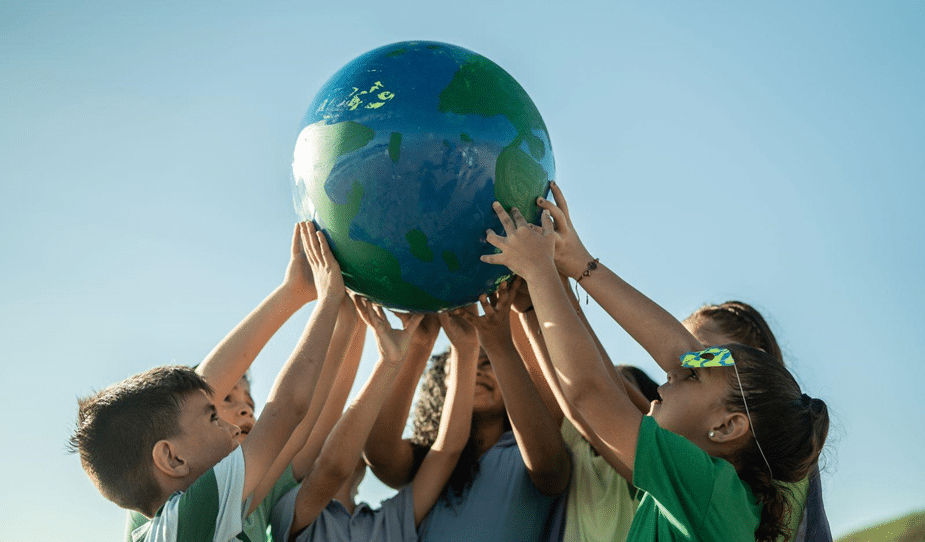 Children holding up a globe