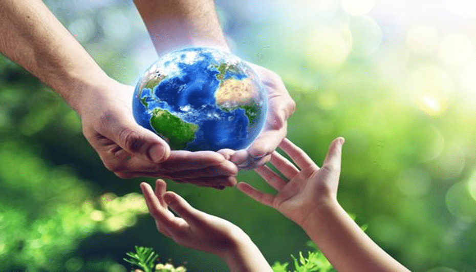 Hands holding the earth against a green background