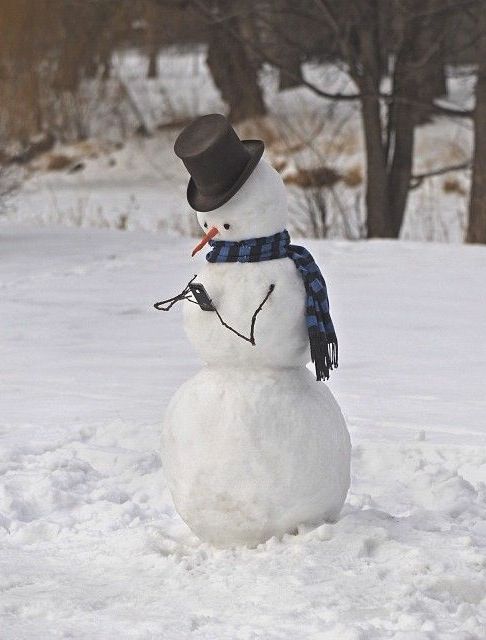 A snowman wearing a hat and scarf, showcasing its creativity with a unique and stylish hat