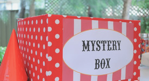 A red and white polka dot mystery box, part of the Mystery Box Adventure Game for Kids