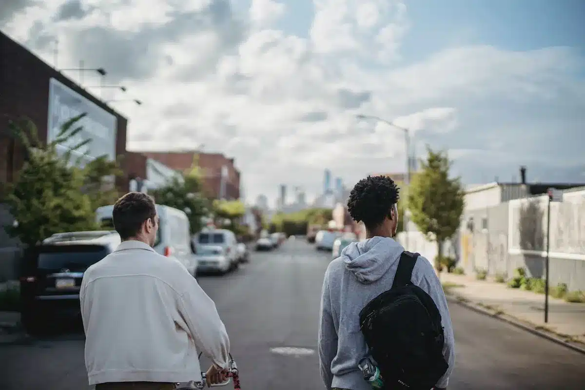 Two young men walking down the street, exploring the neighborhood together