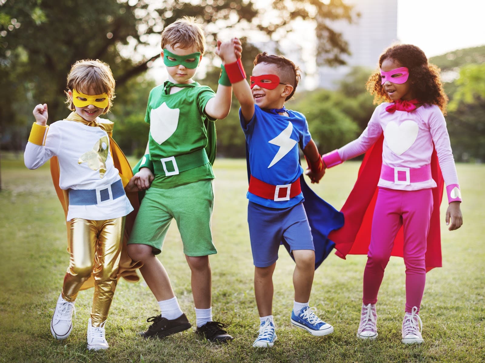 Four children dressed as superheroes