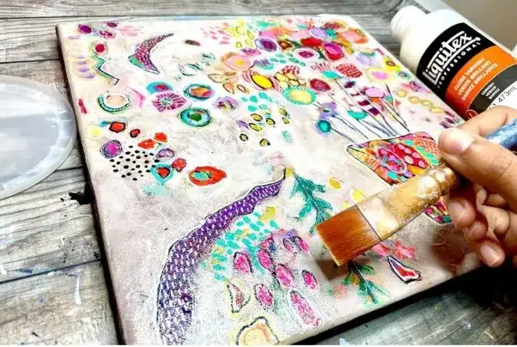 A person creating a vibrant abstract painting on paper. Learn how to seal watercolor paintings