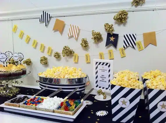 
A table with popcorn, candy, and decorations for a Movie Marathon.