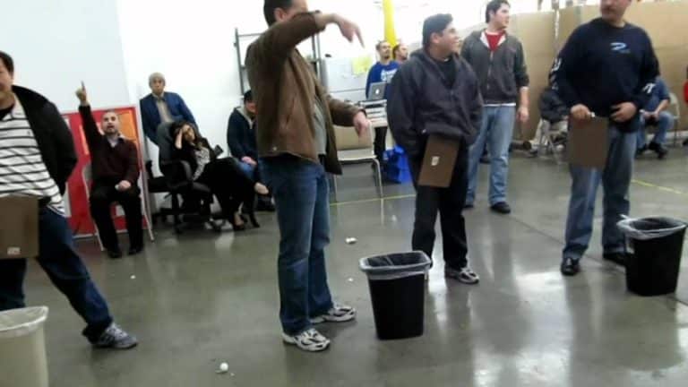 A lively gathering of individuals enjoying No-Equipment Party Games in a warehouse setting