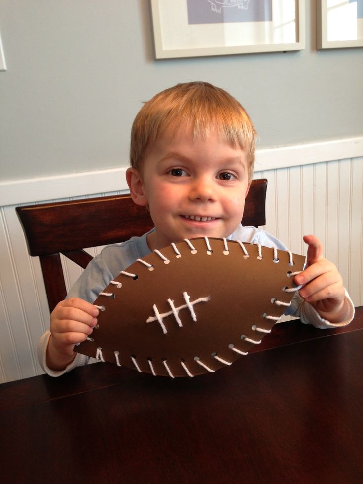 a kid making football frmo a paper plate